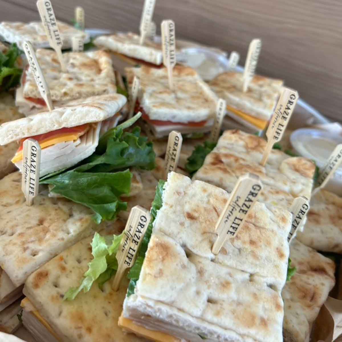 Small sandwiches with visible ingredients on a plate